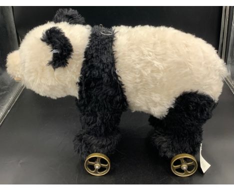 A Steiff panda on brass wheels with growler mechanism. 55 l x 39cms h. No. 400452Condition ReportGood condition.