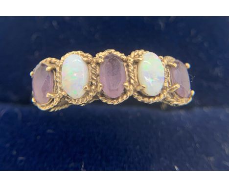 A 9ct gold and opal ring. Size N 2.2gms.Condition ReportGood condition.