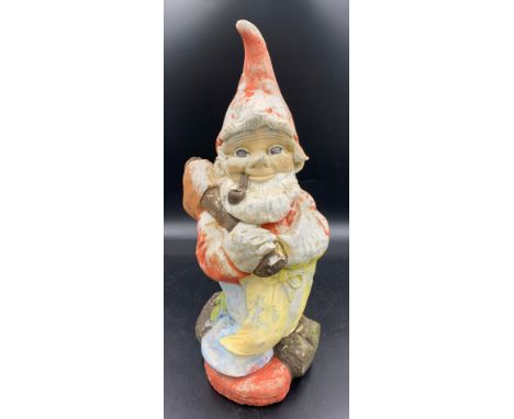 A vintage reconstituted stone pipe smoking gnome astride a log. 48cms h.Condition ReportWear to paint.