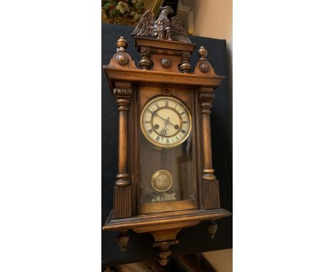 A 19thC wall clock with eagle pediment and white enamel dial. 80cms h.