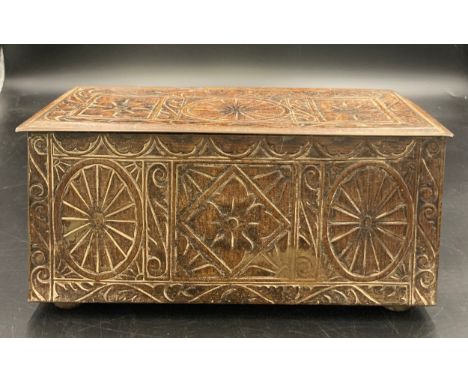 A vintage biscuit tin in the form of a carved oak coffer. 27 x 12 x 12cms h.Condition ReportGood condition.
