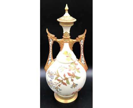 A Royal Worcester lidded vase with floral decoration and pierced dragon headed handles. 41cms.Condition ReportGilt wear to ha