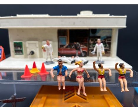 Three garages with a collective mix of similar scale figures and signs(850g)includes metal die-cast Dinky (2) and J.Hill fing