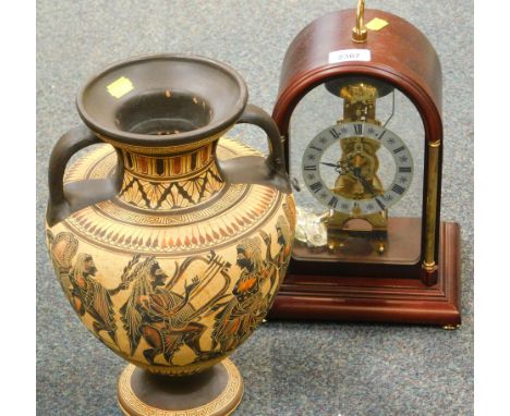 A mahogany cased Kundo mantel clock, and an Egyptian style two handled vase. 