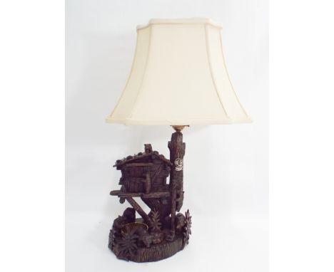 Black Forest carved bear in a tree house musical box novelty table lamp, makers label Prince to the back 37cm tall 