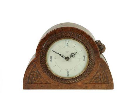 Robert Mouseman Thompson (1876-1955): An English Oak Mantel Clock, dated 1940, the face surrounded by repeating carving, with