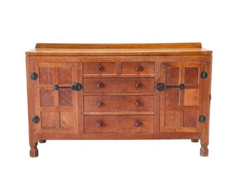 Robert Mouseman Thompson (1876-1955): An English Oak 5ft Panelled Sideboard, circa 1950s, with raised upstand above two cupbo