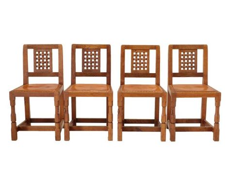 Workshop of Robert Mouseman Thompson (Kilburn): A Set of Four English Oak Lattice-Back Dining Chairs, tan hide seats, on two 