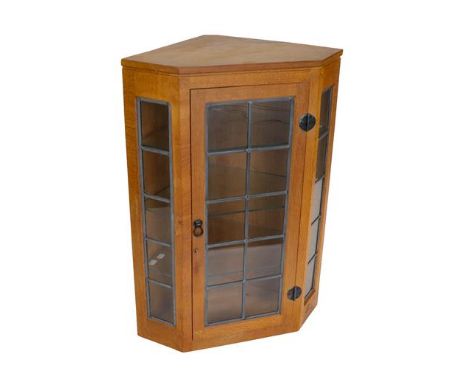 Workshop of Robert Mouseman Thompson (Kilburn): An English Oak Glazed Hanging Corner Cupboard, the leaded glazed door and sid