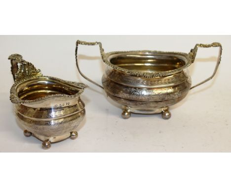 A GEORGE III ENGRAVED TWO HANDLED SUGAR BASIN and MILK JUG with gadrooned and shell decoration. London 1817. Maker: T.W. & J.