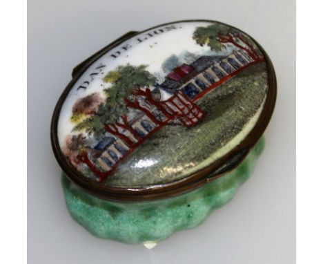 AN 18TH CENTURY OVAL ENAMEL PATCH BOX AND COVER, the lid painted with a view DAN DE LION. 1.75ins wide.
