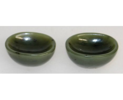 A PAIR OF CHINESE GREEN JADE OVAL SALTS. 5cms long.