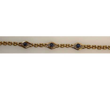 A GOOD SAPPHIRE AND DIAMOND BRACKET, set in 9ct yellow gold with three sapphires and diamonds.