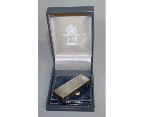 A DUNHILL SILVERED GAS LIGHTER in original box.
