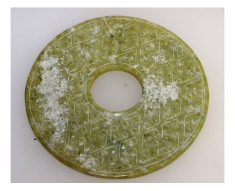 A CHINESE CARVED JADE CIRCULAR DISC. 13cms diameter.