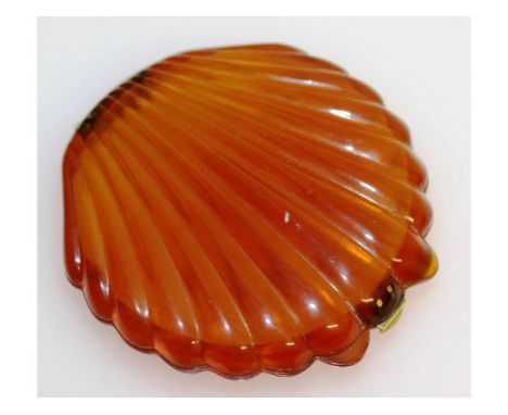 A BLONDE SHELL SHAPED CIGARETTE COMPACT, with silver fittings. 7cms x 7.5cms.