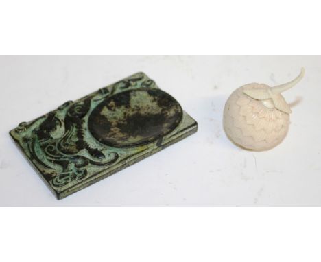 A CARVED IVORY FRUIT POMANDER, 3cms diameter, and A GREEN JADE DISH carved with a dragon, 8cms x 5cms.