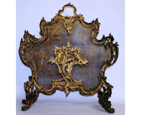 A GOOD LOUIS XVI ORMOLU FIRESCREEN with rush work back, scrolls and cupids. 30ins high.