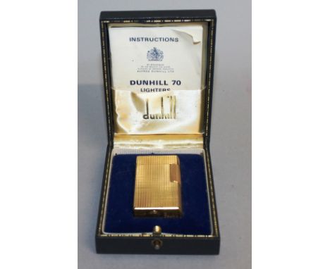 A DUNHILL 70 GOLD COLOURED GAS LIGHTER, No. AV932, in original blue box.