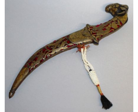 A 19TH CENTURY INDIAN CURVING DAGGER with gilded sheath and handle, and engraved blade.