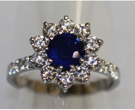 A SAPPHIRE AND DIAMOND CLUSTER RING, set in 18ct white gold.