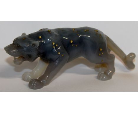 A CARVED AND GILDED JADE LEOPARD. 6ins long.