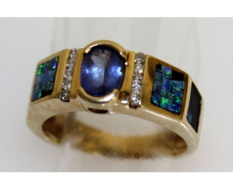 A TANZANITE, DIAMOND AND OPAL RING in 14ct yellow gold.