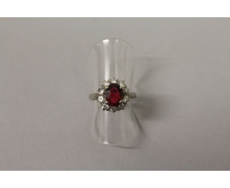 A LOVELY RUBY AND DIAMOND OVAL CLUSTER RING in 18ct white gold and platinum.