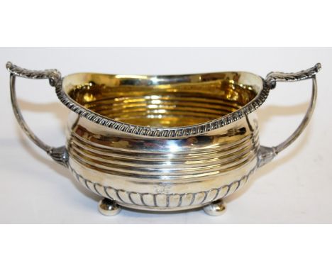 A GEORGE III OVAL TWO HANDLED SUGAR BASIN with gadrooned edge, acanthus handles on ball feet. London 1815. Maker: Rebecca Eam