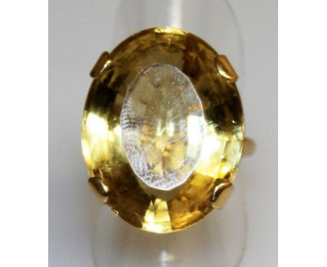 A LARGE CITRINE SOLITAIRE OVAL RING set in 18ct yellow gold.