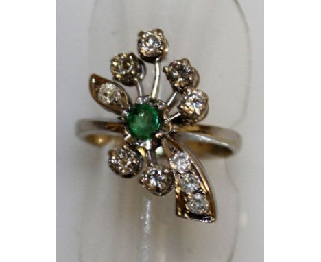 A GOOD EMERALD AND DIAMOND "FLOWER" SET CLUSTER RING set in white gold.