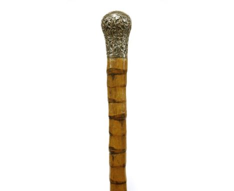 An Anglo-Burmese hardwood walking stick with silver knop,c.1870, raised with three attendants, the shaft carved spirally with