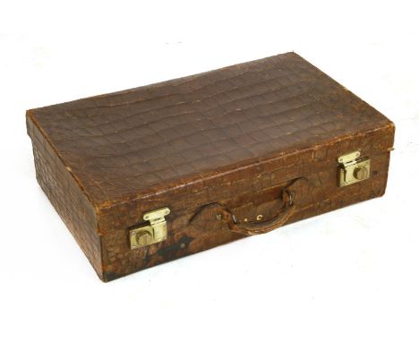 A crocodile skin suitcase,c.1900, initialled 'M S', with substantial brass locks,65cm wide