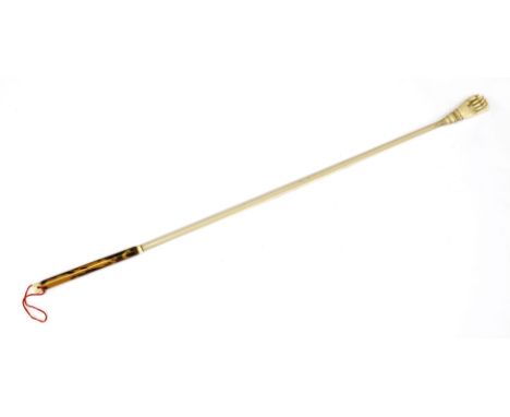 An Anglo-Indian ivory and tortoiseshell back scratcher,c.1860, the finial in the form of a hand, the shaft with penwork decor