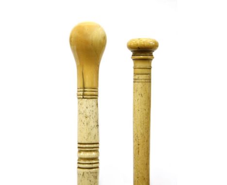 Two marine ivory walking sticks,the first with a flattened disc and line turned handle, over a tapering shaft,85.5cm long,the