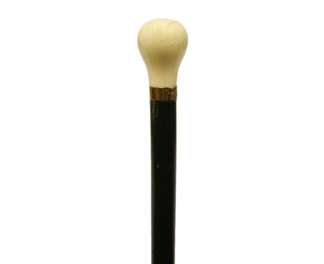 An art deco ebony and ivory 'dress' walking stick,with a spherical knop and 9 carat gold band, hallmarked London, 1930, 92cm 