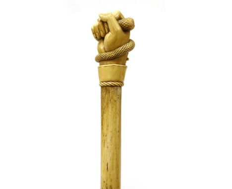 A marine ivory and whalebone walking stick,the top finely carved with a hand gripping a serpent, the cuff with a mother-of-pe