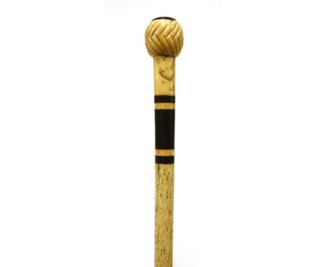 A marine ivory and whalebone walking stick,with a handle as a chevron carved ball with tortoiseshell disc, over three baleen 