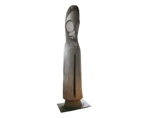 A monumental ni-Vanuatu slit drum,20th century, carved hardwood,274cm high (9ft)Slit drums are among the most widespread musi