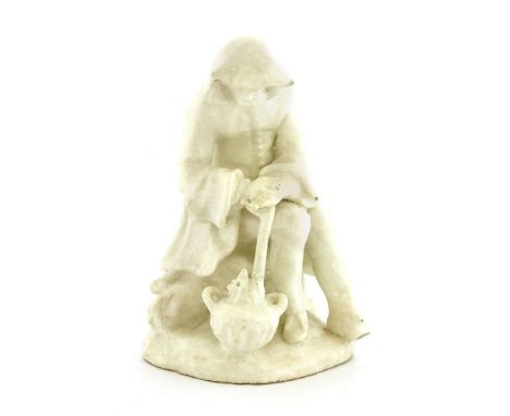 A Bow white-glazed figure representing winter,c.1755, an old man, seated and leaning on a stick by a brazier, 12.5cm high