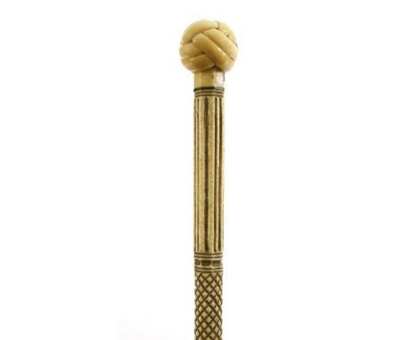 A marine ivory and whalebone walking stick,the handle carved as a Turk's head knot over a baleen disc above vertical fluted, 