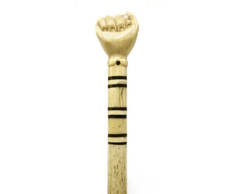 A marine ivory and whalebone walking stick,with a clenched hand over six baleen discs, on a plain tapering shaft,89.5cm long