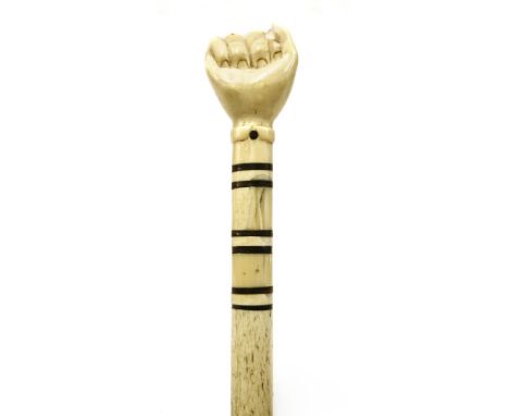 A marine ivory and whalebone walking stick,with a clenched hand over six baleen discs, on a plain tapering shaft,89.5cm long