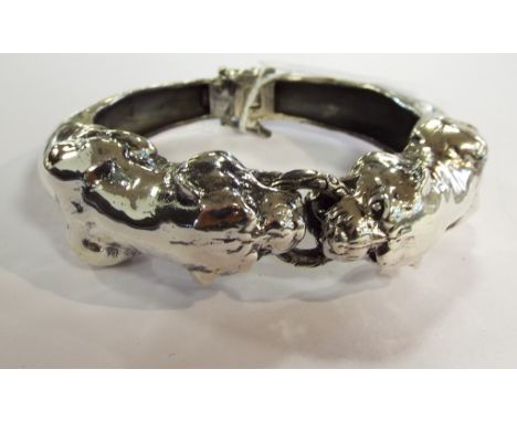 A silver bangle, in the form of two panthers