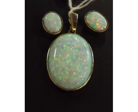 A 9ct gold and Gilson created opal pendant, and a matching pair of stud earrings