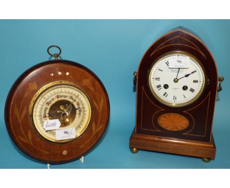 A mantel clock, the white dial with Roman numerals signed Searle & Co, in an inlaid mahogany lancet shaped case, 27.5 cm high