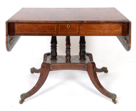 A 19th century rosewood sofa table, with brass line inlay, on four turned supports, a concave sided platform base, and four d