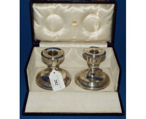 A pair of silver dwarf candlesticks, Asprey & Co, Birmingham 1907, 8 cm high, cased
 Condition report Report by GH

These can