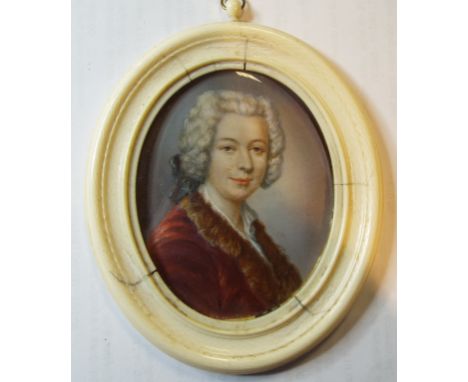 An oval portrait miniature, of a gentleman with a fur collar, watercolour on ivory, 8 x 6 cm, in an ivory frame