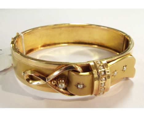A 15ct gold and seed pearl bangle, in the form of a stylised buckle Condition report Report by GH

Approx. 21.5 g

Report by 